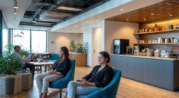 Staff in breakroom area with coffee and snacks