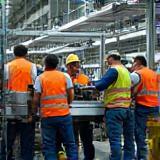 Team installing assembly line equipment